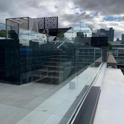 Custom glass railing installation by Toronto Metal and Iron Railings